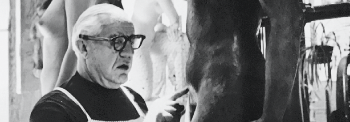 Victor Bergeron works on a sculpture of a nude woman